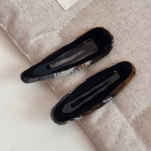 Détail de pinces à cheveux BB en tissu écossais marron et beige pour l'automne-hiver