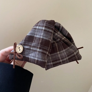 Close-up of vintage brown plaid hair claw with wooden button and bow detail