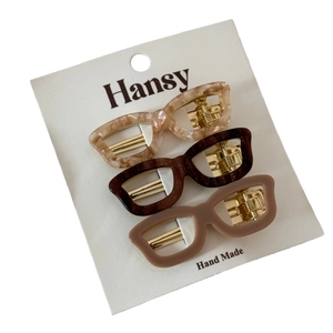 Three-piece set of star-shaped acetate hair clips in marble and glitter finishes