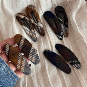 Détail de barrettes à carreaux vintage en tissu de laine avec texture automnale