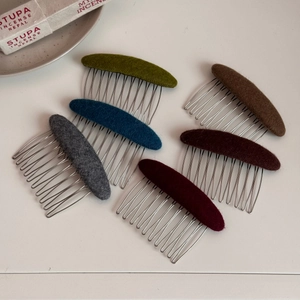 Detailed set of six wool felt hair combs in autumn colors like olive and navy blue