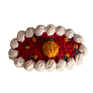 Handmade crochet orange fruit hair clip with cute red and white knit pattern for girls