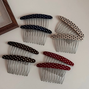 Close-up of retro acetate polka dot hair side combs in multiple vintage colors