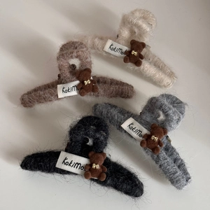 Set of four fluffy bear hair claws in cream, coffee, grey, and charcoal colors