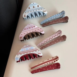 Detail showing various acetate hair clips with cute bear and kitten cartoon patterns