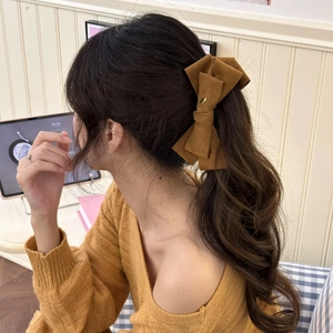 Detailed back view of a large brown velvet double-layered bow banana hair clip for women