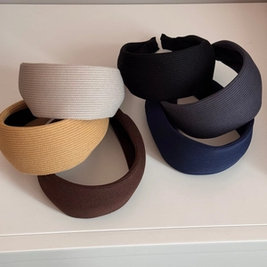 Detail of multi-color thick knitted striped headbands in various colors for hair styling