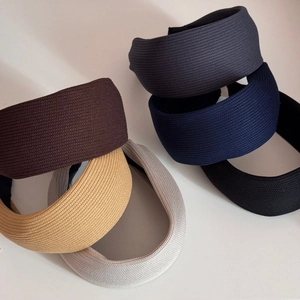 Detail showing various colors and soft knit texture of wide striped headbands for women