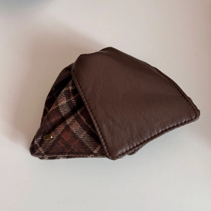 Detail view of triangular faux leather hair claw with vintage brown plaid fabric design