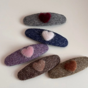 Detail of 5-piece plush heart tweed hair clips set with classic herringbone texture