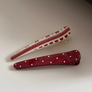 Polished acetate hair clip set featuring red heart patterns and classic white polka dots