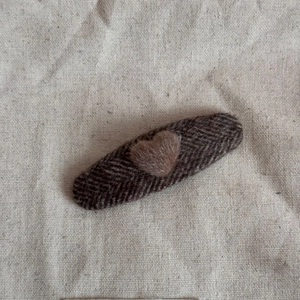 Close-up of heart plush hair clip with brown herringbone fabric and soft wool texture