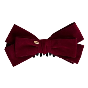 Elegant large burgundy velvet double bow banana clip with gold metal tag on white background