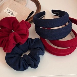 Detail of navy and deep red woven fabric headbands and scrunchies with handmade labels