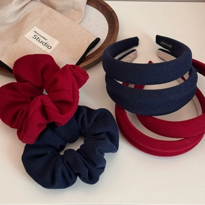 Close-up of vintage knit texture headbands and matching scrunchies in red and navy