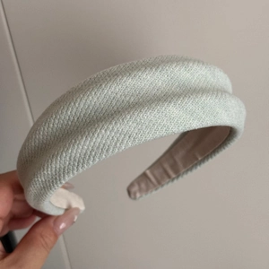 Detailed macro view of mint green fabric sponge headband with textured knit material