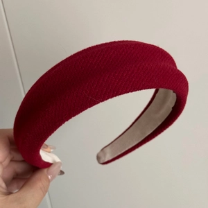 Detailed shot of a thick wine red sponge headband with non-slip inner fabric lining