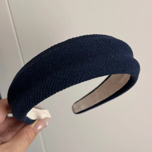 Detailed view of dark blue sponge headband showing premium twill fabric texture and inner lining