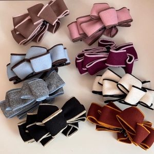 Set of 8 colorful faux suede bow banana hair clips with textured contrast stitching