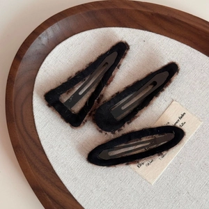 Close-up of three black plush edge BB hair clips with brown faux fur trim set