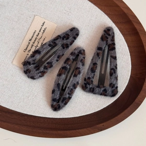 Three-piece leopard print plush hair clips set in a vintage wooden tray display