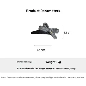 Detailed view of grey knitted bow hair clip showing dimensions of 9.5cm and 5.5cm
