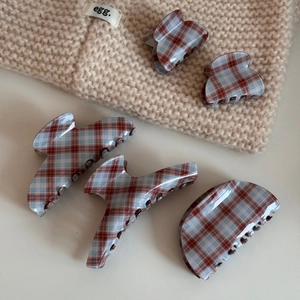 5-piece vintage red and blue plaid acetate claw clip set on beige knit fabric background