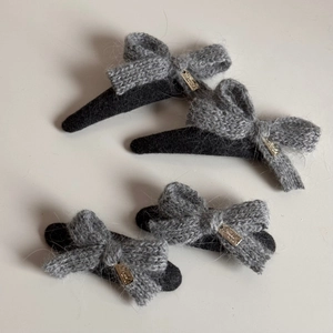 Set of four gray knitted bow hair clips with elegant gold metal plaques for women