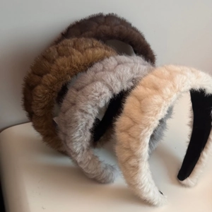 Detail view of plush wide headbands in four colors with woven texture and non-slip inner band