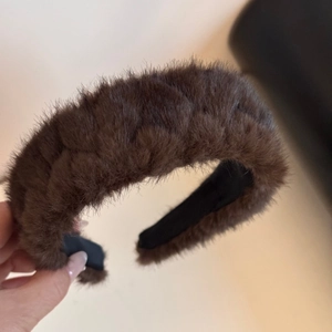 Detail showing plush deep brown faux fur texture on a wide headband for winter styles