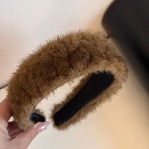 Detail of plush brown faux fur headband showing soft texture and non-slip inner lining