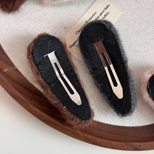 Detailed back view of plush heart hair clips showing secure silver metal BB clip attachment