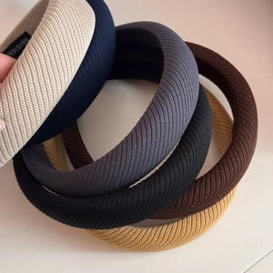 Détail de six serre-têtes en éponge tricotée colorée montrant la texture et le rembourrage