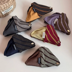 Detail showing high-quality knitted stripe triangle hair clips with handmade labels