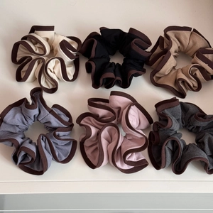 Detailed top view of six-piece large elastic scrunchies set with contrast piped edges