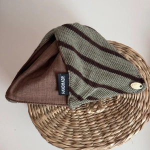 Detail showing knit striped fabric texture and handmade label on the large triangle hair clip