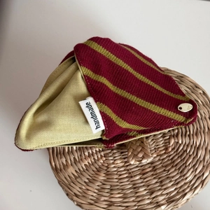 Close-up of handmade striped fabric hair claw clip with a luxury knit texture and gold detail
