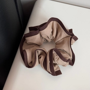 Detailed macro view of retro high-elasticity scrunchie with contrasting color edge texture