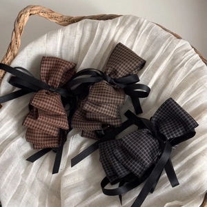 Three premium houndstooth bow hair clips with elegant black ribbons in a vintage style