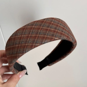 Detail view of retro red brown plaid wide tweed headband with non-slip inner lining