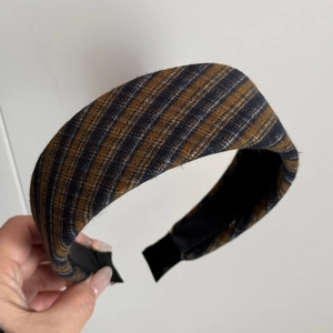 Detail of wide padded headband featuring vintage British style knit stripes in brown and blue