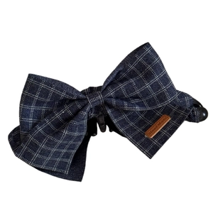 Navy blue plaid fabric bow banana hair clip with handmade leather tag on white background
