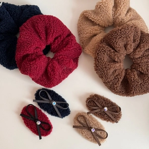Set of large teddy fleece scrunchies and bow hair clips in navy, wine, and brown tones