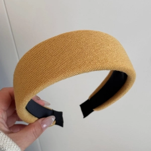 Detail of mustard yellow knitted wide headband with thick padded 3D texture and non-slip lining