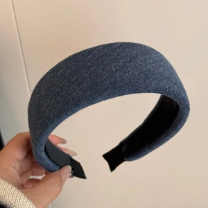Detail of navy blue knitted headband showing vertical texture and non-slip inner lining