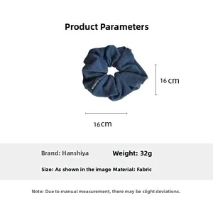 Detailed view of large blue fabric scrunchie with size 16cm and weight 32g info