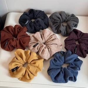 Detail of soft knitted fabric textures and colorful hair scrunchies set in various colors
