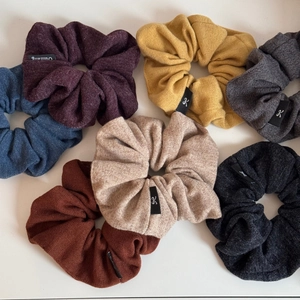 Set of seven knitted large scrunchies in diverse colors with detailed fabric texture