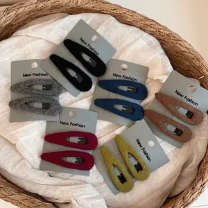 Set of two velvet teardrop BB hair clips in autumn colors on a card display