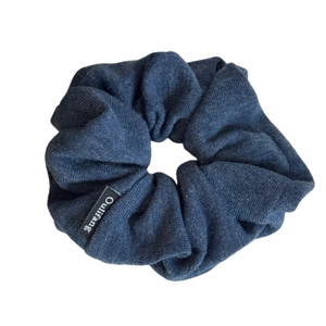 Dark blue knitted scrunchie hair tie with fine texture and brand woven label